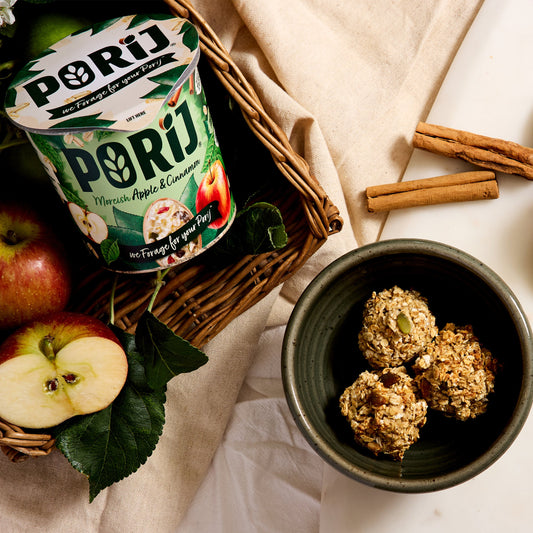 Pori snack package with apples, cinnamon sticks, and a bowl of snacks on a white surface.